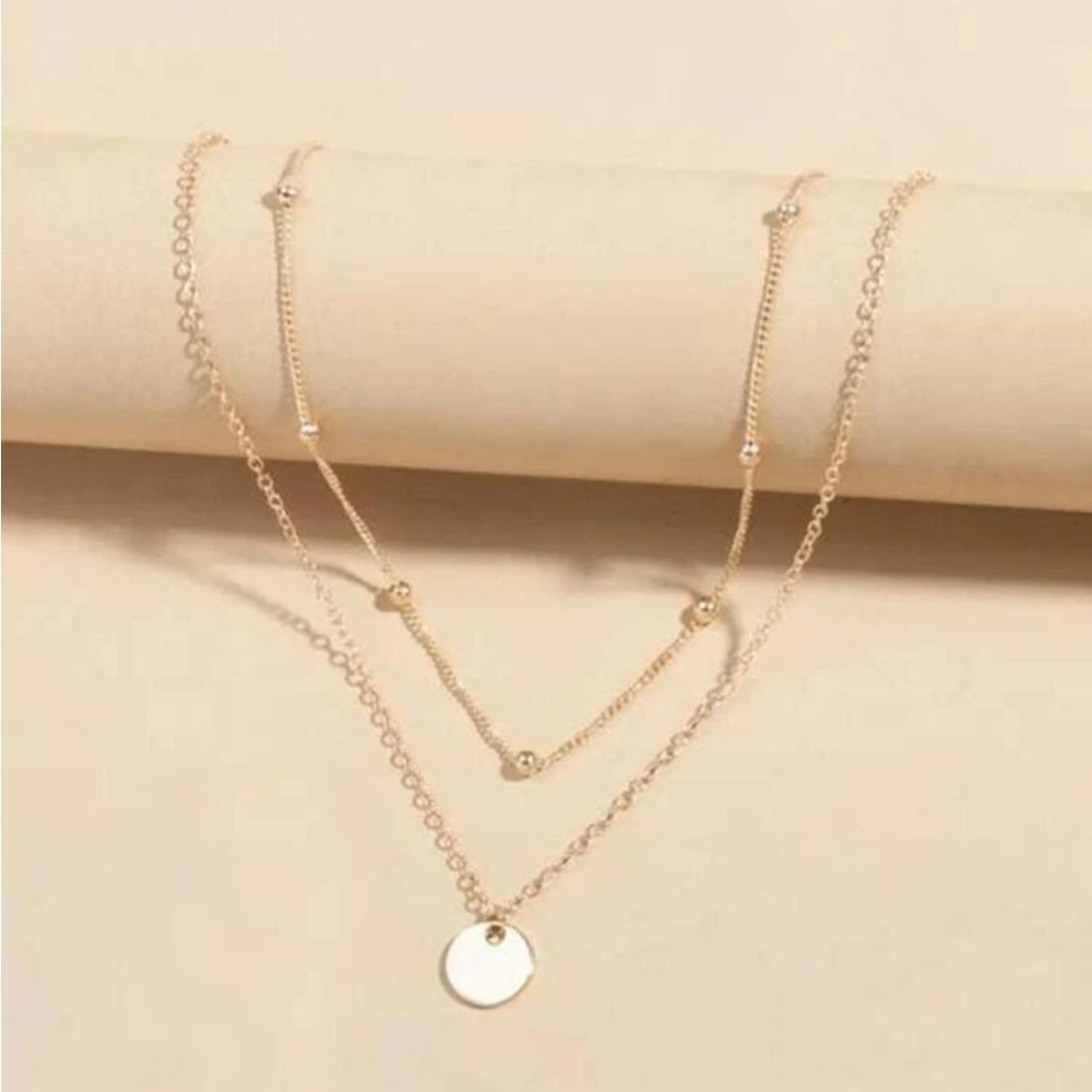 Gold tone coin layered necklace